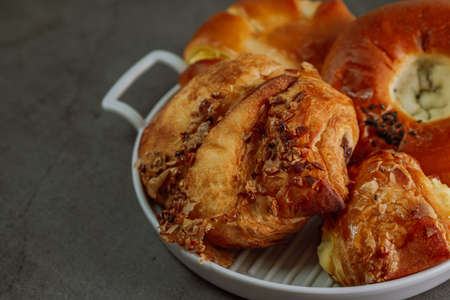 Delicious brownish bread snacks on a gray plate