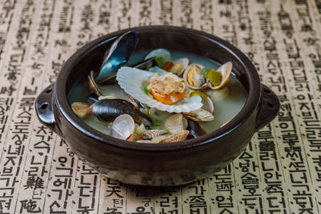 Jogae tang, Korean style clam soup : Soup with clams in their shells and vegetables in a clam broth, seasoned with red chili pepper powderの写真素材