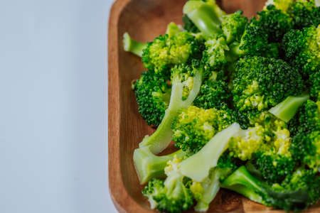 Vegetarian food. Broccoli on wooden plateの写真素材
