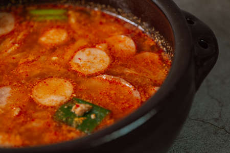 Buddaejjigae, Korean style spicy stew of wieners, luncheon meat, macaroni and vegetables.の写真素材