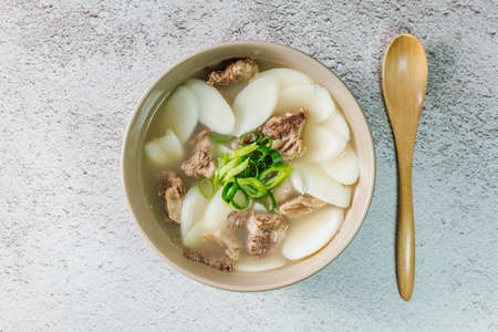 Tteokguk, Korean Sliced Rice Cake Soup : Oval-shaped rice cake cooked in broth. A traditional Lunar New Year dish. Clear beef broth is most commonly used, but chicken or seafood may be added.の写真素材