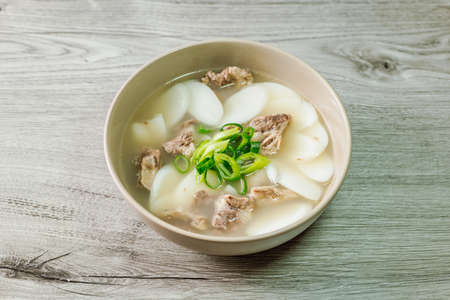 Tteokguk, Korean Sliced Rice Cake Soup : Oval-shaped rice cake cooked in broth. A traditional Lunar New Year dish. Clear beef broth is most commonly used, but chicken or seafood may be added.の素材 [FY310180590634]