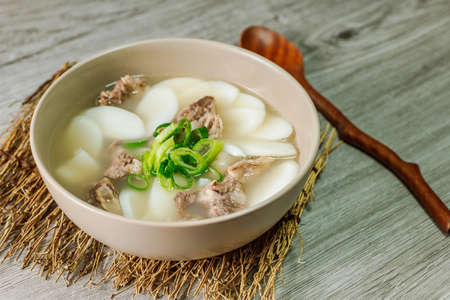 Tteokguk, Korean Sliced Rice Cake Soup : Oval-shaped rice cake cooked in broth. A traditional Lunar New Year dish. Clear beef broth is most commonly used, but chicken or seafood may be added.の写真素材
