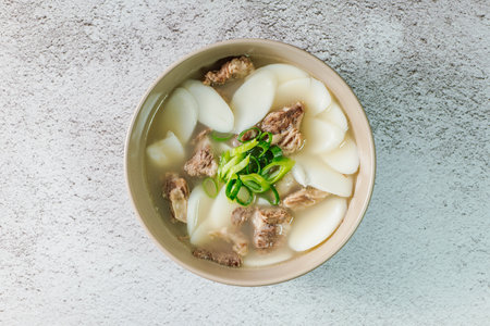 Tteokguk, Korean Sliced Rice Cake Soup : Oval-shaped rice cake cooked in broth. A traditional Lunar...