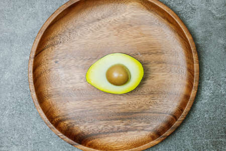Avocado Fruit in Wood Plate