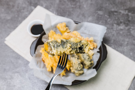 Deep-fried Laver Roll, Deep-fried Squid snack on a black plateの写真素材