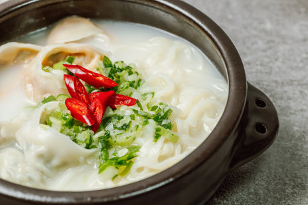 Korean style noodle soup with dumplings, mandu kalguksuの写真素材