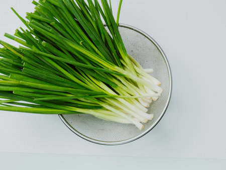 bunch of fresh chives on the tableの写真素材
