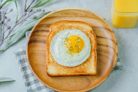 Fried egg crispy toast food on wood plate