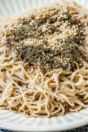 Korean food perilla oil makguksu dish with seaweed sprinkled on a plateの写真素材