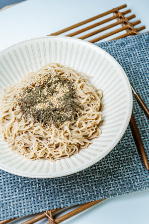 Korean food perilla oil makguksu dish with seaweed sprinkled on a plateの写真素材