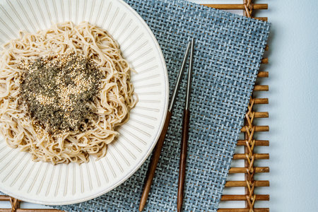 Korean food perilla oil makguksu dish with seaweed sprinkled on a plateの写真素材