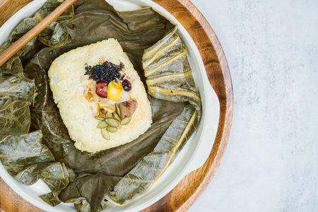 yeonnipbap, korean lotus leaf rice, glutinous rice, dates, and chestnuts wrapped in a lotus leaf and steamed in a steamer. In the past, this dish was made and consumed by Buddhist monks, but it is now popular among health-conscious peopleの写真素材