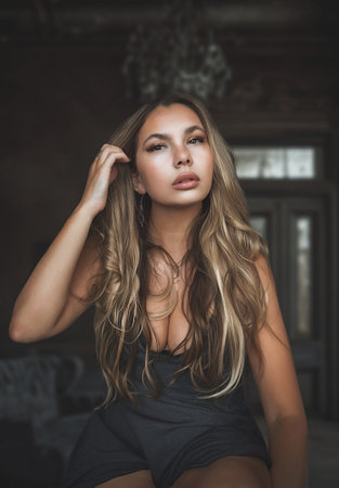 Portrait of a beautiful girl with long hair in the interior.