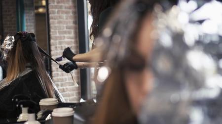 The hairdresser paints a hair to the girl. lose-upの写真素材