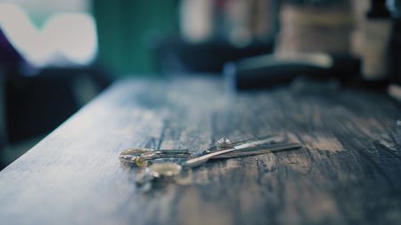 Woman is putting hairdressers scisors on table in hair salon. Closeup viewの写真素材