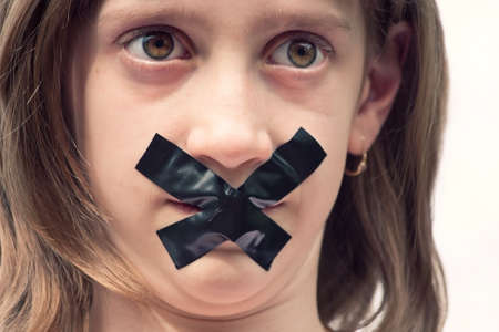 teenager portrait with scotch tape over mouth