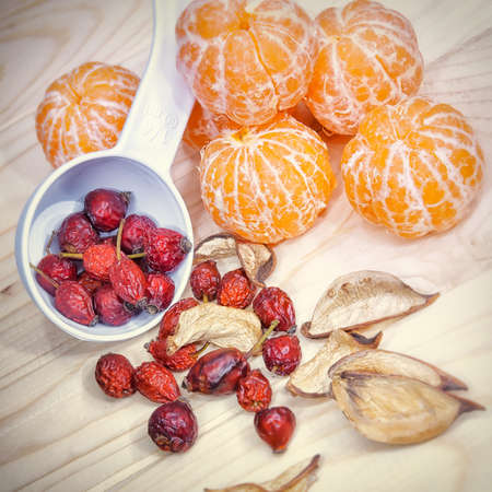 tangerine and haw at wooden plate backgroundの写真素材