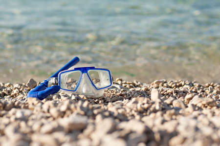 diving mask glasses and pipe at summer beachの写真素材