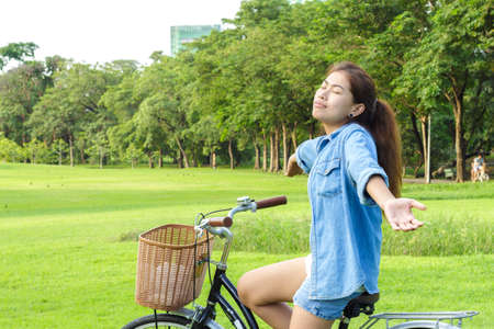 woman feeling fresh in park on summer dayの写真素材