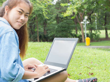 smile woman use laptop computer in the parkの写真素材