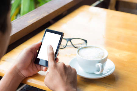 man use smart phone in coffee shopの写真素材