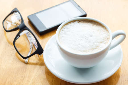 close up coffee cup on wood tableの写真素材