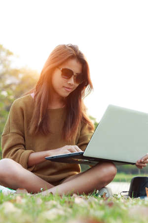 girl smile use laptop notebook computer outdoor modern lifestyleの写真素材