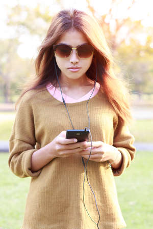 women use smart phone listen to musicの写真素材