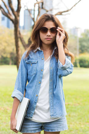 portrait young women wear eyeglass and jeans shirt fashionの写真素材