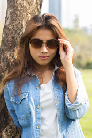 closeup portrait smart women and eyeglass with jeans fashionの写真素材