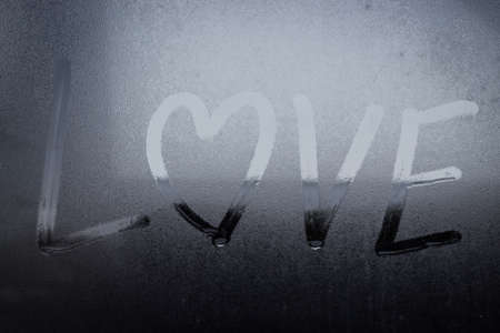 text love and heart sharpe on water drop glassの写真素材