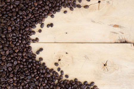 coffee beans on grain wood backgroundの写真素材