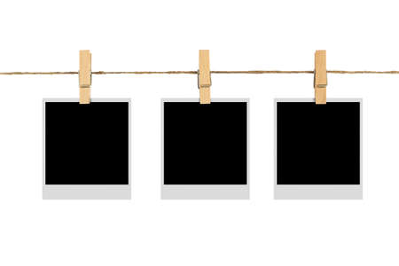 blank photo frame on cloth line isolated white backgroundの写真素材