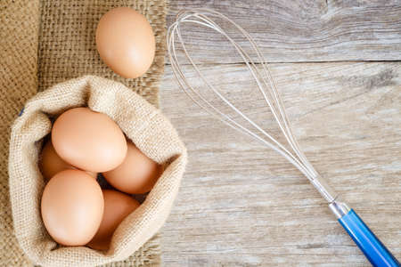 chicken egg raw food on grain wood backgroundの写真素材