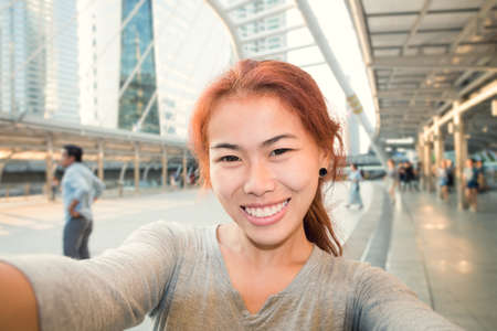 young women take selfie photo in city backgroundの写真素材