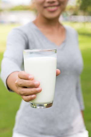 women gesture hand hold milk in glass healthy lifstyleの写真素材