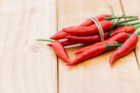 closeup red chili peppers spice ingredient on wood table