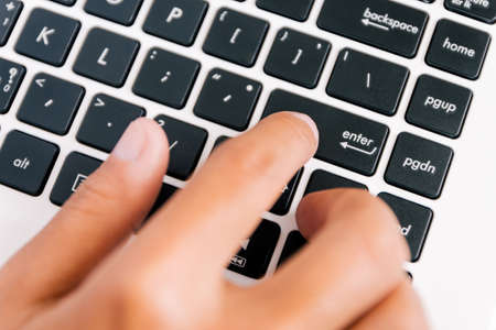 hand press enter button on keyboard computerの写真素材