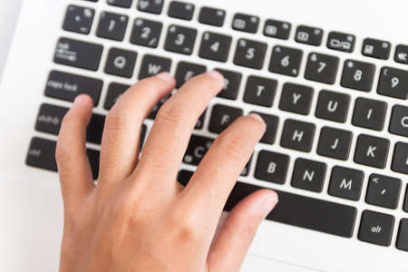 close up hand type on laptop keyboardの写真素材