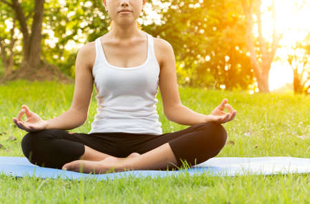 woman was meditation yoga in park at eveingの写真素材