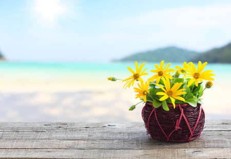 flower vase on wood table and beach backgroundの写真素材