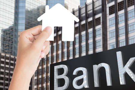 hand hold home paper business finance conceptの写真素材