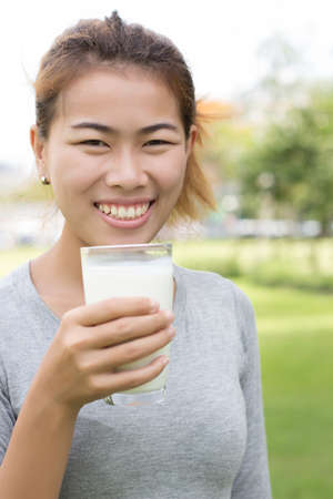 close up woman drinking milk outdoor backgroundの写真素材