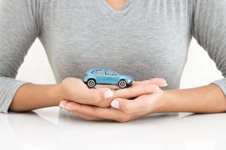 woman holding car model business leasing conceptの写真素材