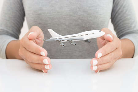 airplane model in woman hand transport conceptの写真素材