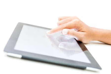 closeup female hand touch on tablet screen on white backgroundの写真素材
