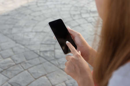 close up woman touch on phone modern lifestyle in cityの写真素材