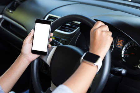 hand holding phone white screen and driving carの写真素材