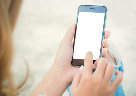 closeup women using phone from back viewの写真素材
